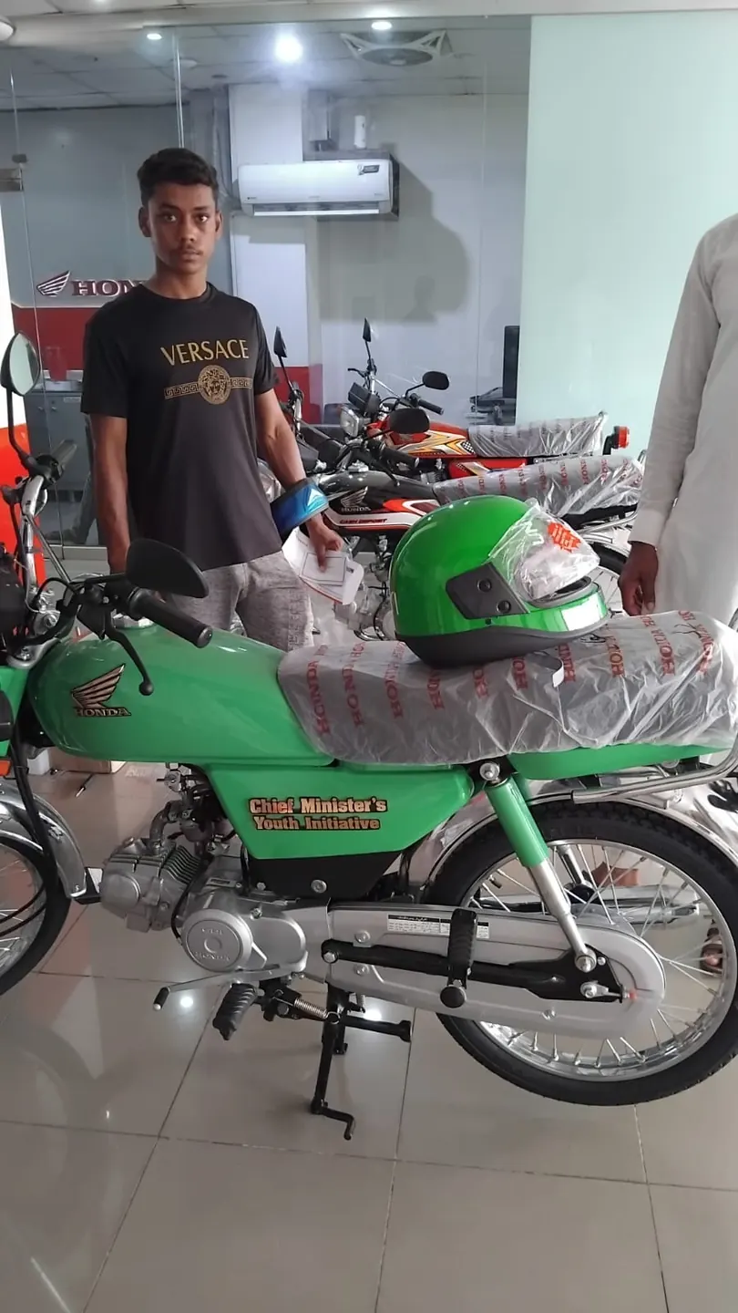 Individual activity photo showing a student with a green motorcycle