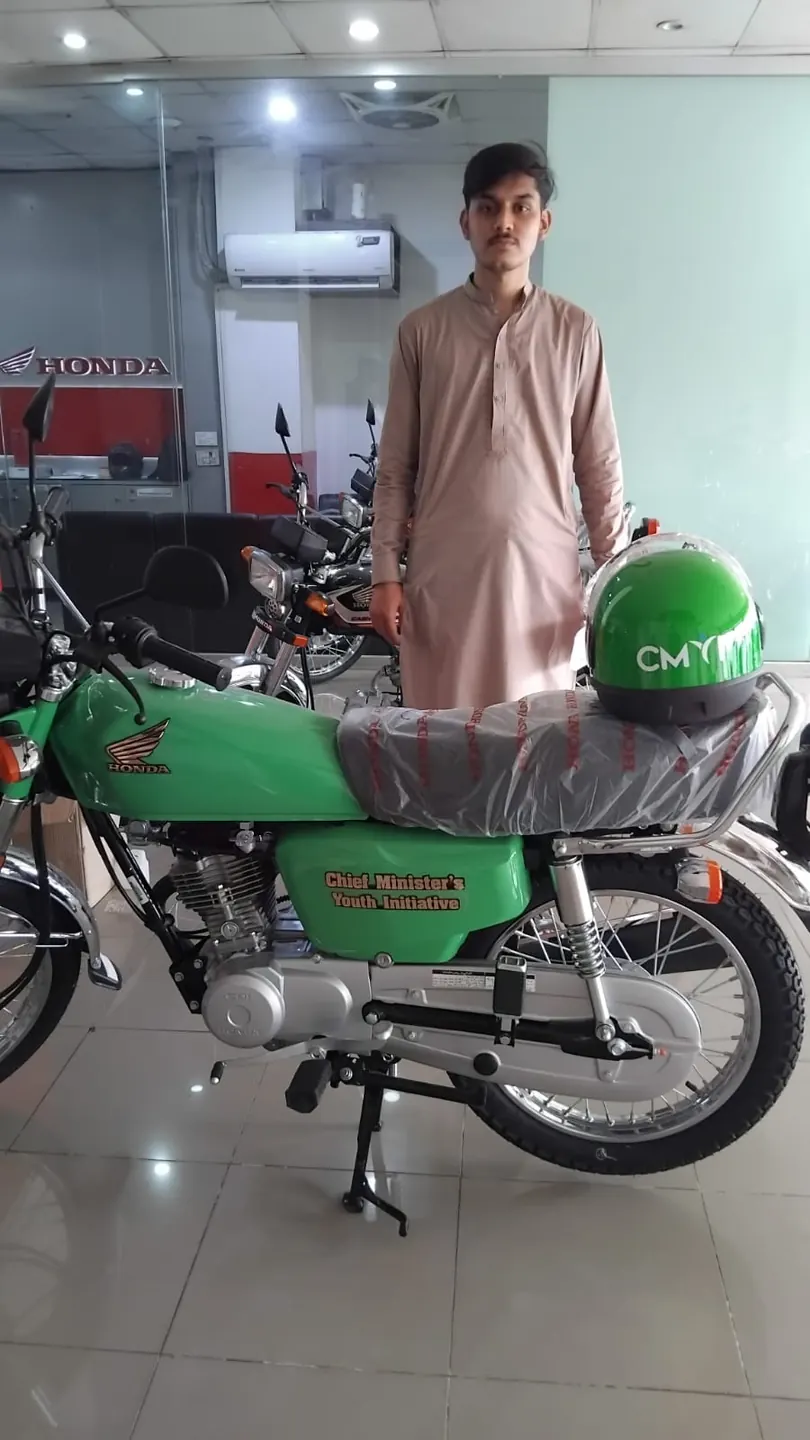 Another student delivery photo with a green motorcycle